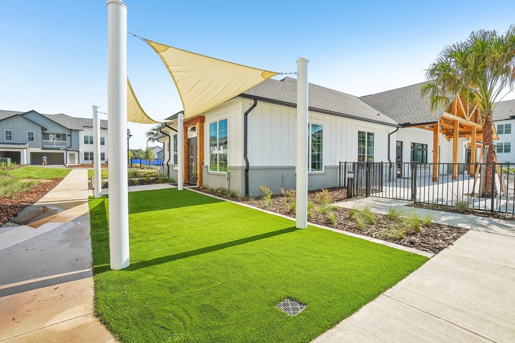 the yards at the community are decorated with lawns and shade structures