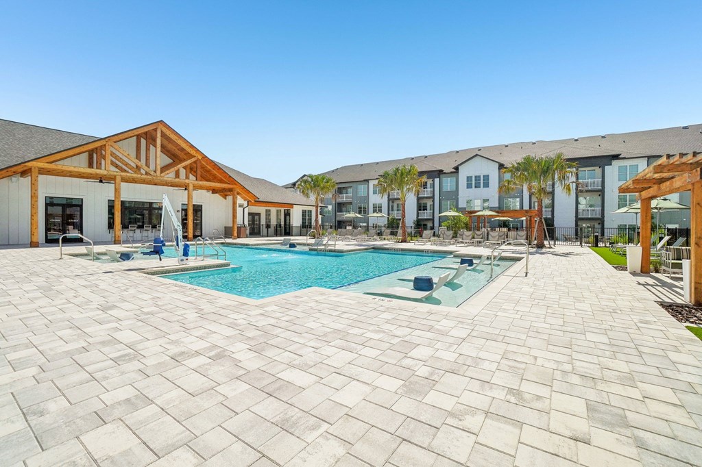 a swimming pool with a building in the background