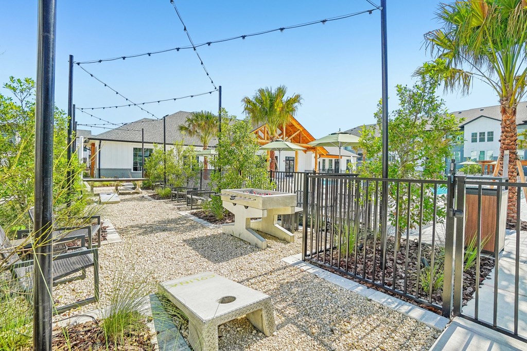 an outdoor patio with a picnic table and a fence