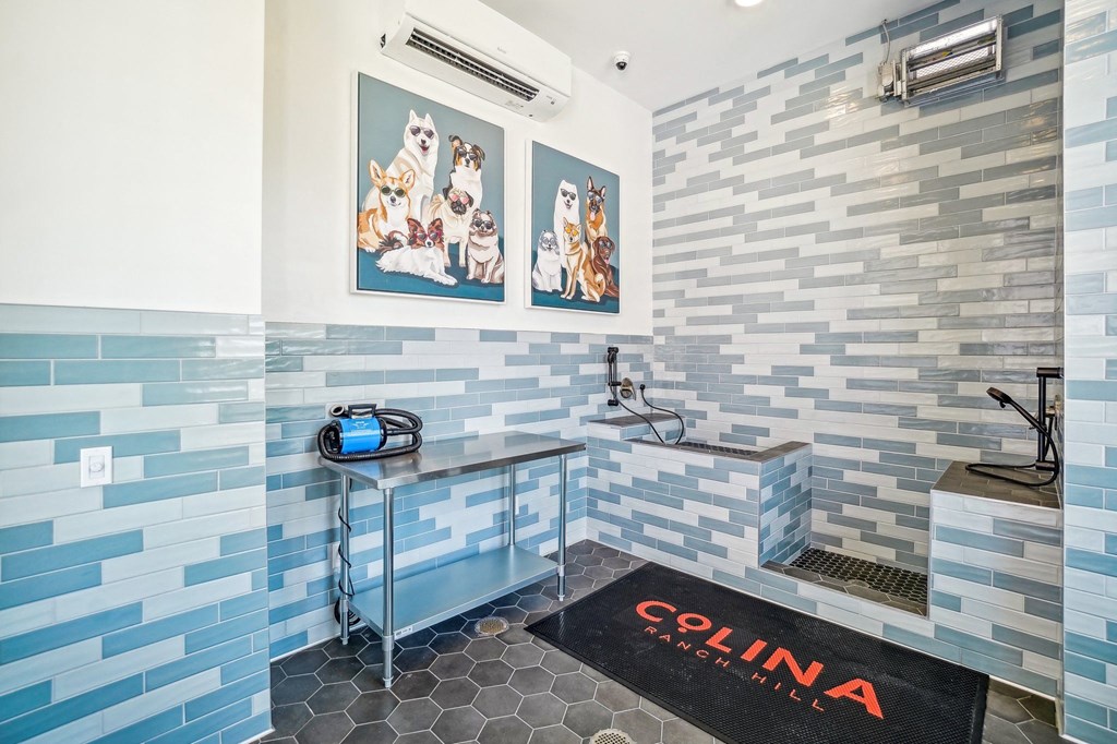 a wet room with blue and white tiles and a shower