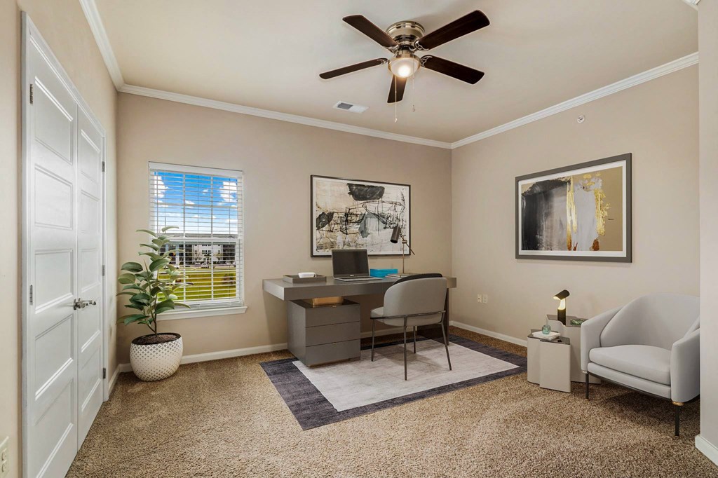 a home office with a ceiling fan