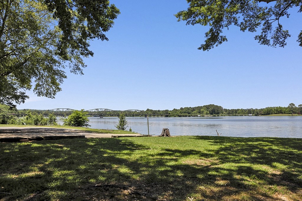 a view of a lake from a greenspace at Riverhouse Apartments in Riverside, AL