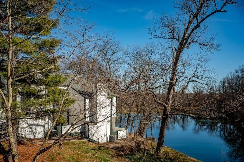 a white house sitting next to a body of water