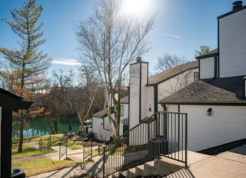 a house with stairs and a river in the background