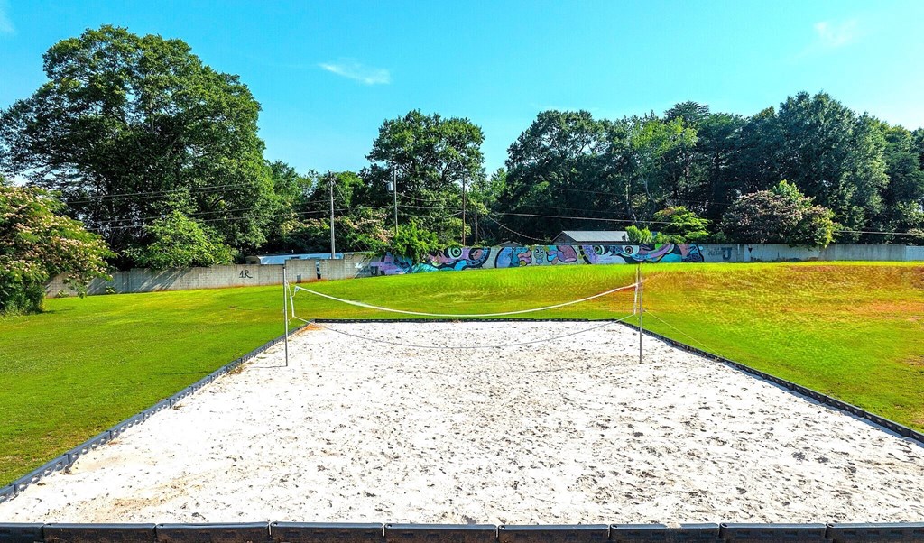 a volleyball court in the middle of a grass field