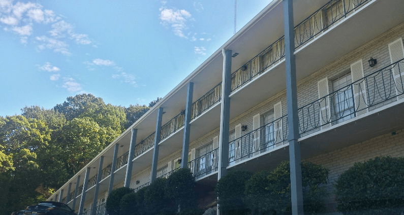 an apartment building with balconies and a blue sky