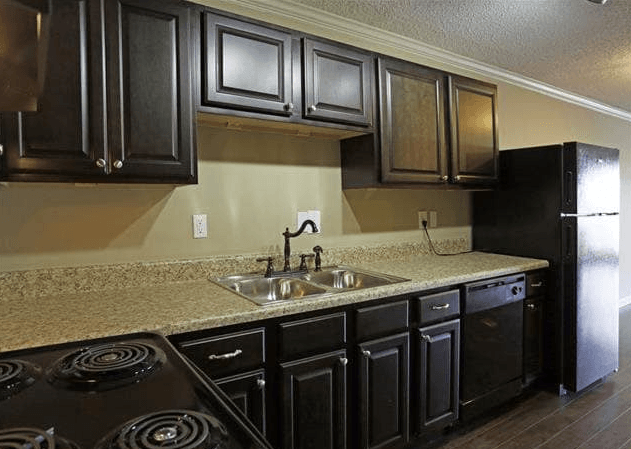 a kitchen with black appliances and a granite counter top