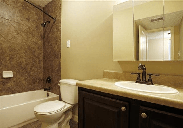 a bathroom with a sink toilet and a bath tub