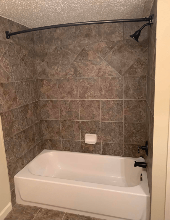 a bathroom with a tub and a shower curtain