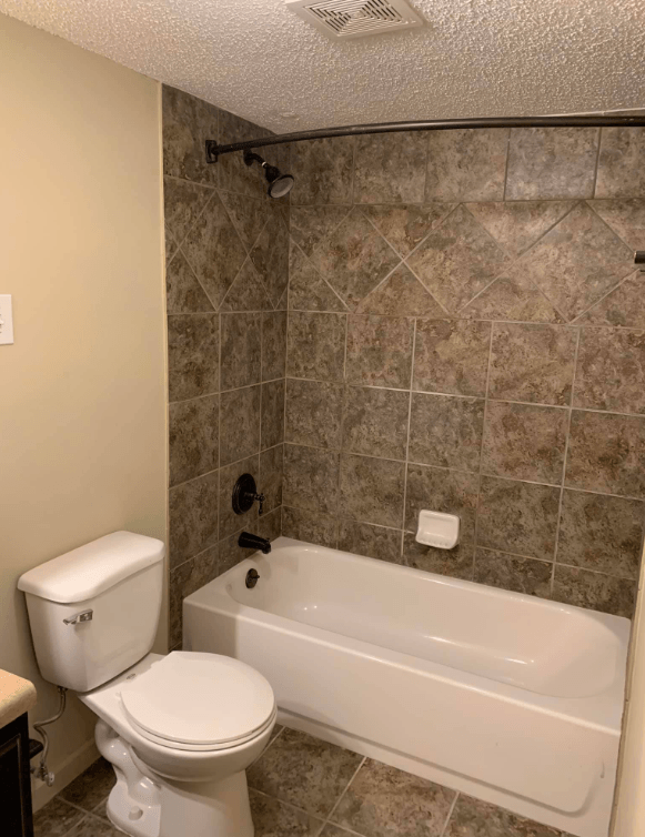 a bathroom with a toilet and a bath tub