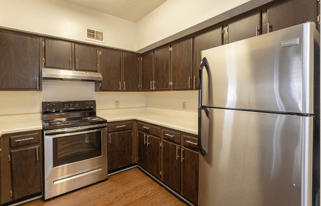 a kitchen with stainless steel appliances and wooden cabinets