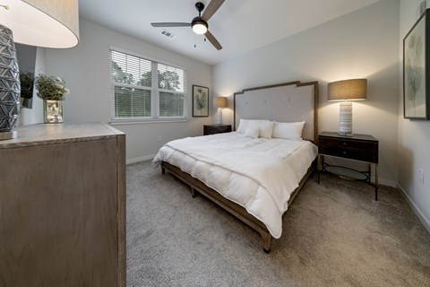 Guest bedroom with king size bed in the Coastal Model at Southern at Santa Rosa