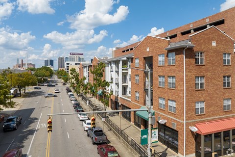 A street view of a city with cars and buildings.