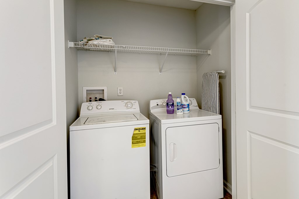 A small laundry room with a washer and dryer.