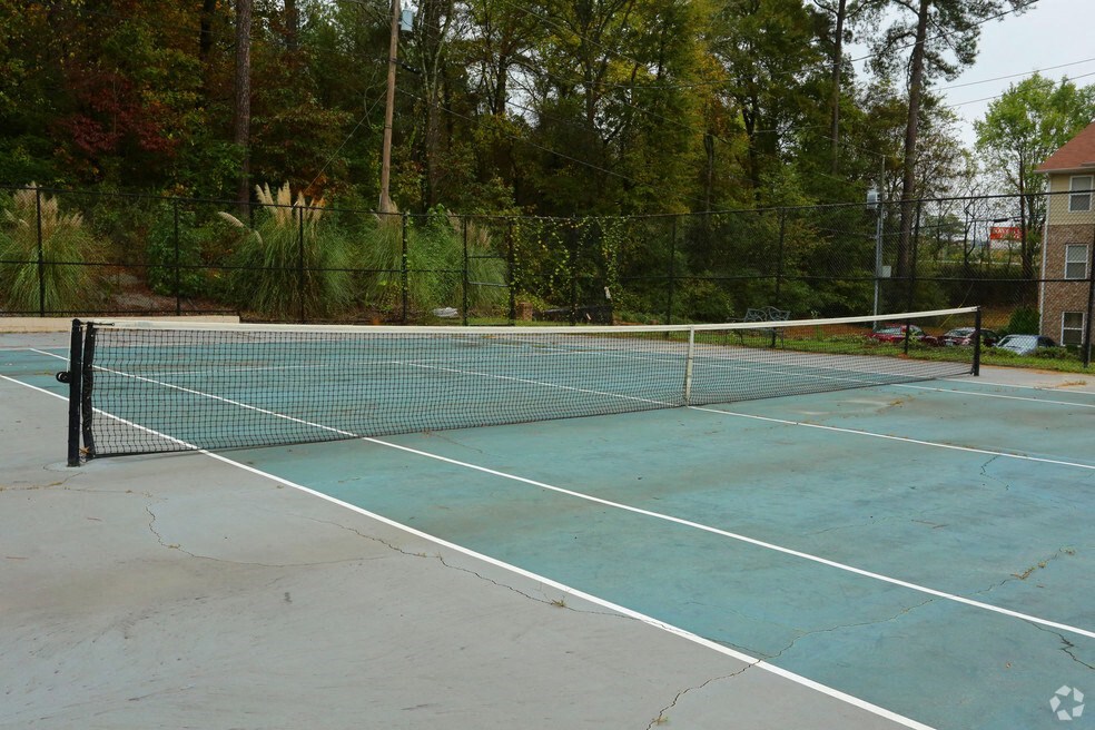 a tennis court with a net on a sidewalk