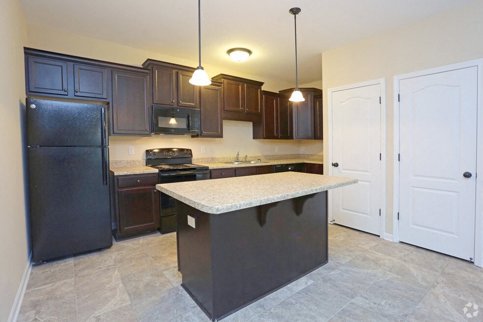 a kitchen with black appliances and a white counter top