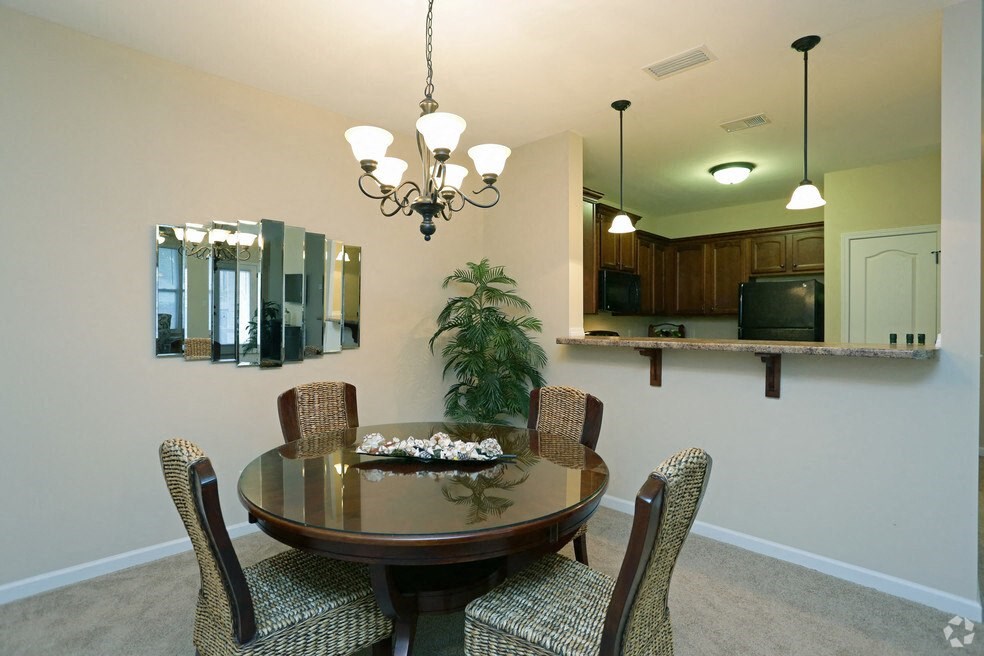a dining room with a table and chairs