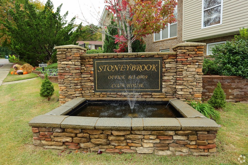 a fountain in the front yard of a house
