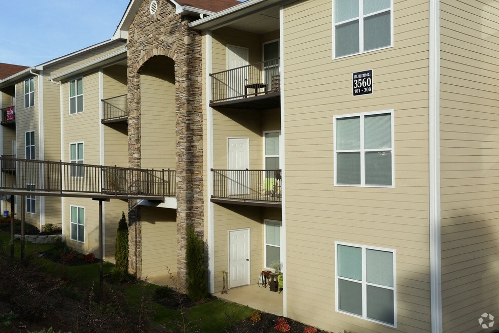 a building with two balconies and a street sign on it