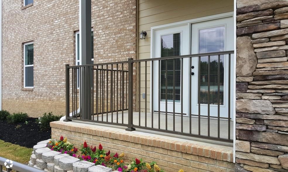 a house with a balcony and a brick wall