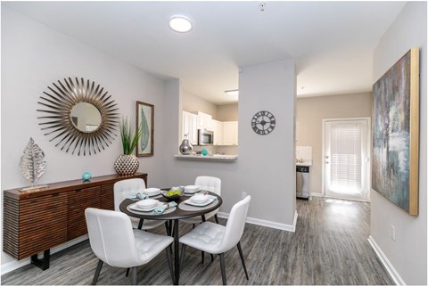 A dining room with a round table and chairs.