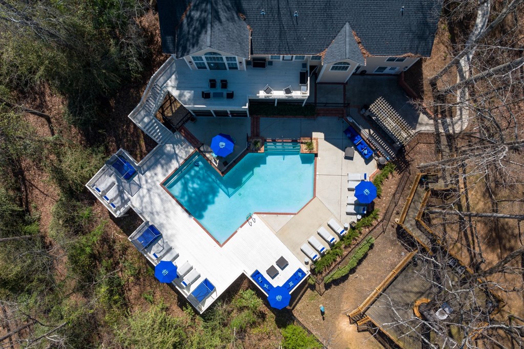Ariel view of a large outdoor swimming pool surrounded by a deck and lounge chairs at Summerchase at Riverchase in Hoover, Alabama.