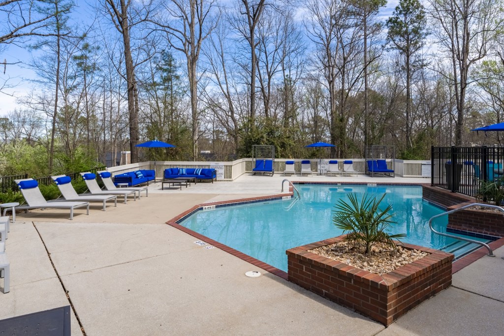 Outdoor pool and deck area with lounge chairs at Summerchase at Riverchase Apartment Homes in Hoover, Alabama.