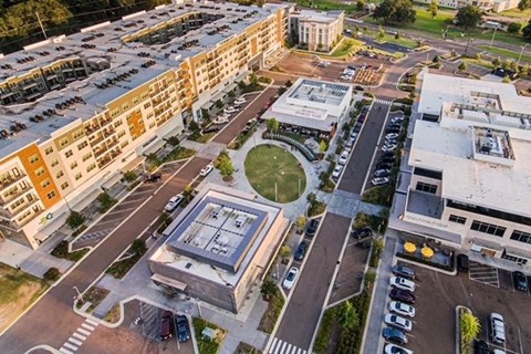 an aerial view of a parking lot and buildings in a city