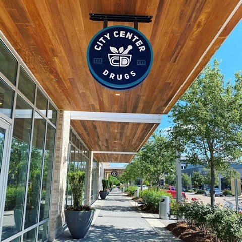 a city center drug store with a sign on the ceiling