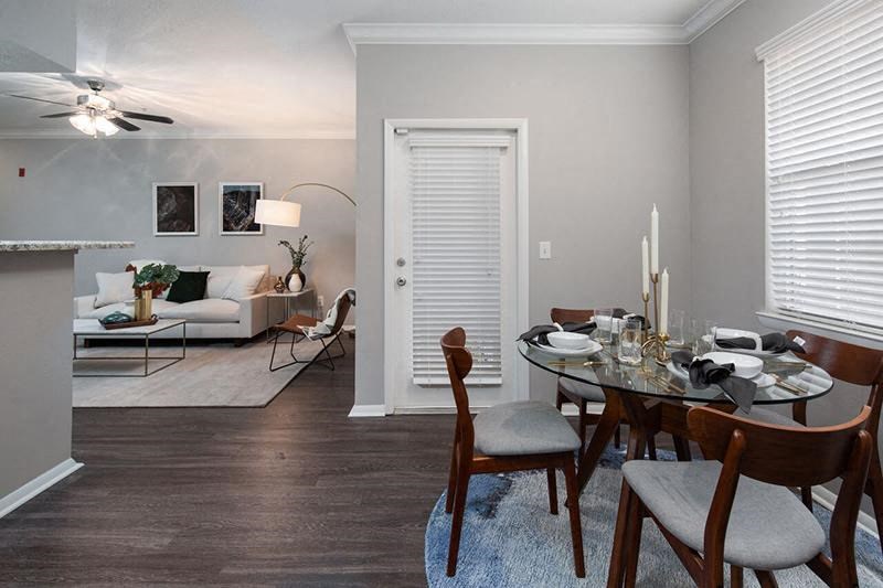 a living room and dining room with a table and chairs