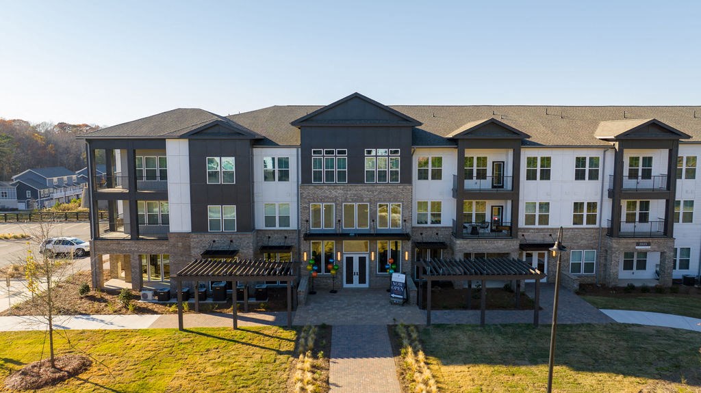 an aerial view of an apartment building with a parking lot