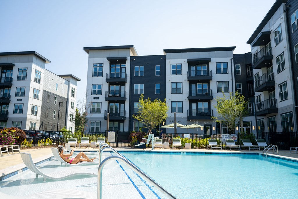 a swimming pool in front of an apartment building