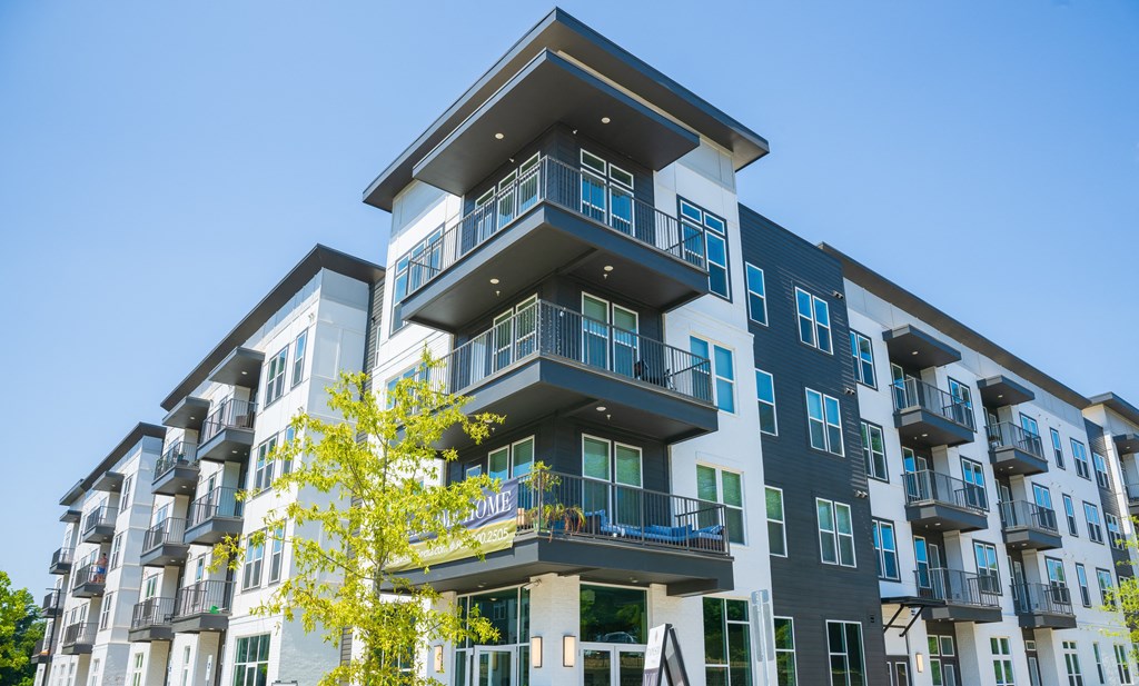 an apartment building with balconies and a blue sky