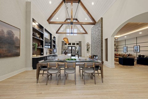 A modern dining room with a wooden table and chairs.