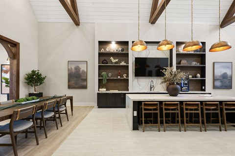 A modern kitchen with a dining table and chairs.
