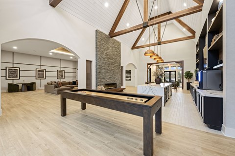 A room with a pool table and a fireplace.