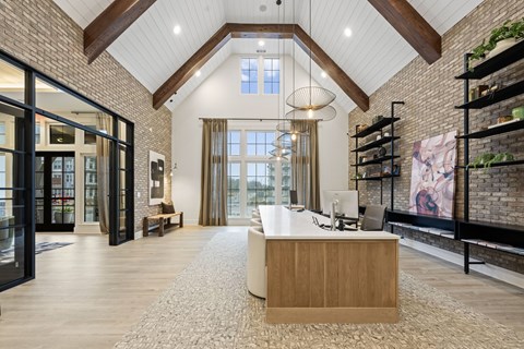 A reception area with a white reception desk and a large window.