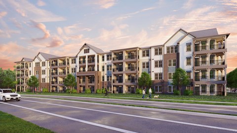 A modern apartment complex with a car parked in front.