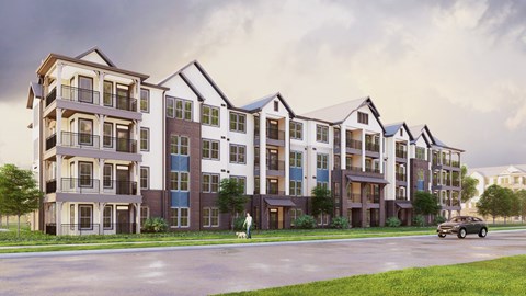 A row of modern apartment buildings with a car driving on the street in front.