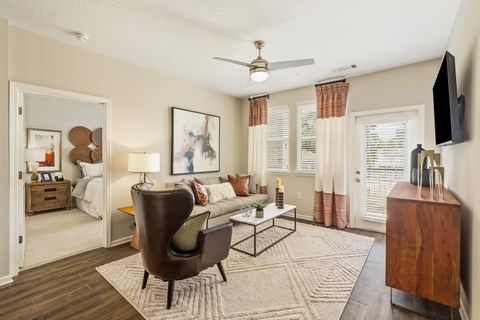 A living room with a brown chair and a white couch.