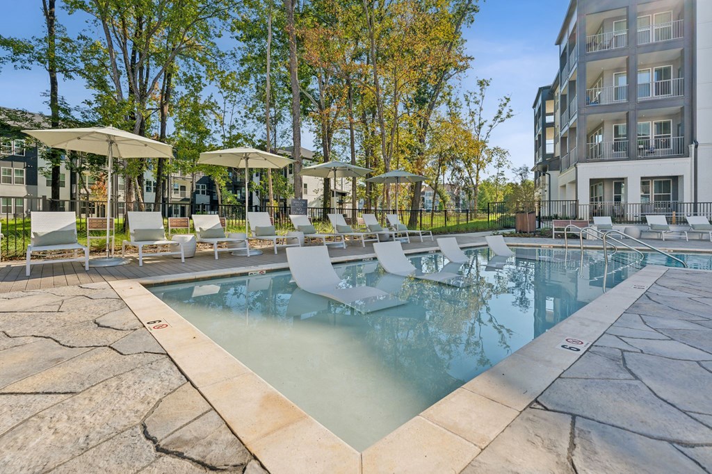 our apartments have a resort style pool with lounge chairs and umbrellas