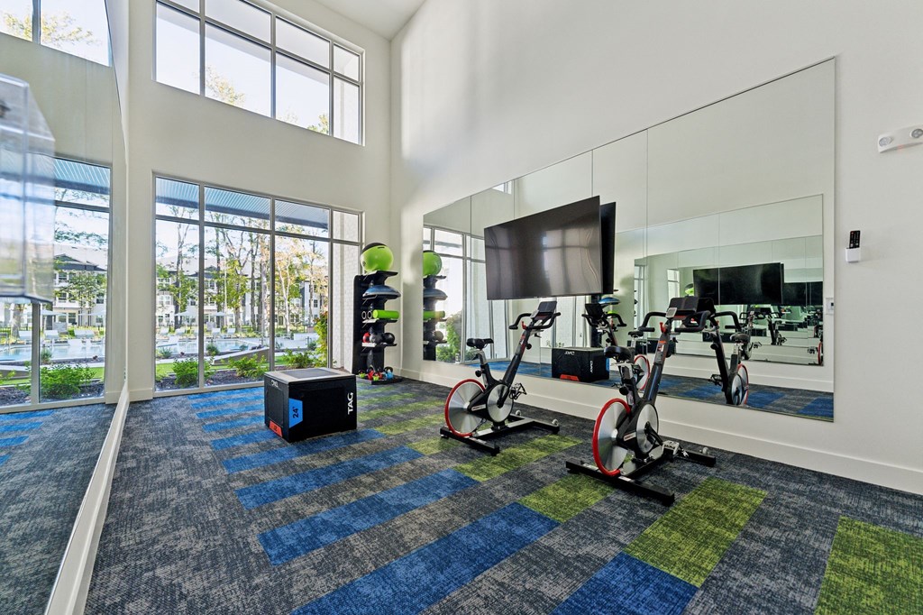 the preserve at ballantyne commons fitness room with weights and a tv