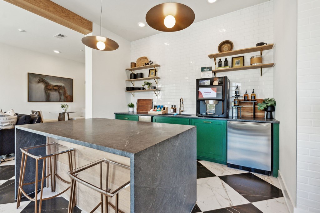 a kitchen with a marble counter top and green cabinets