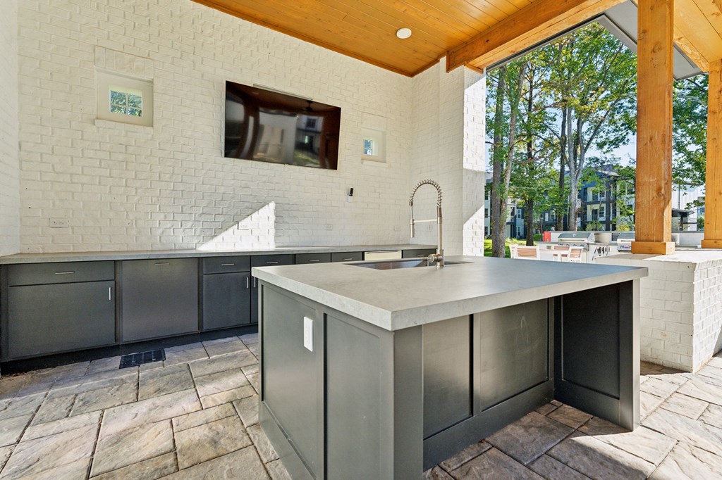 a large kitchen with stainless steel counter tops and a large window
