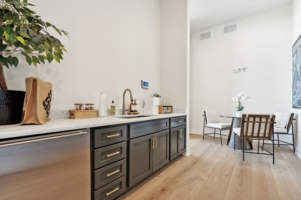 a kitchen with a counter top and a dining room with a table