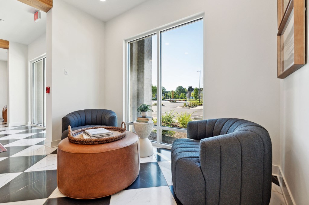a living room with two chairs and a table and a large window