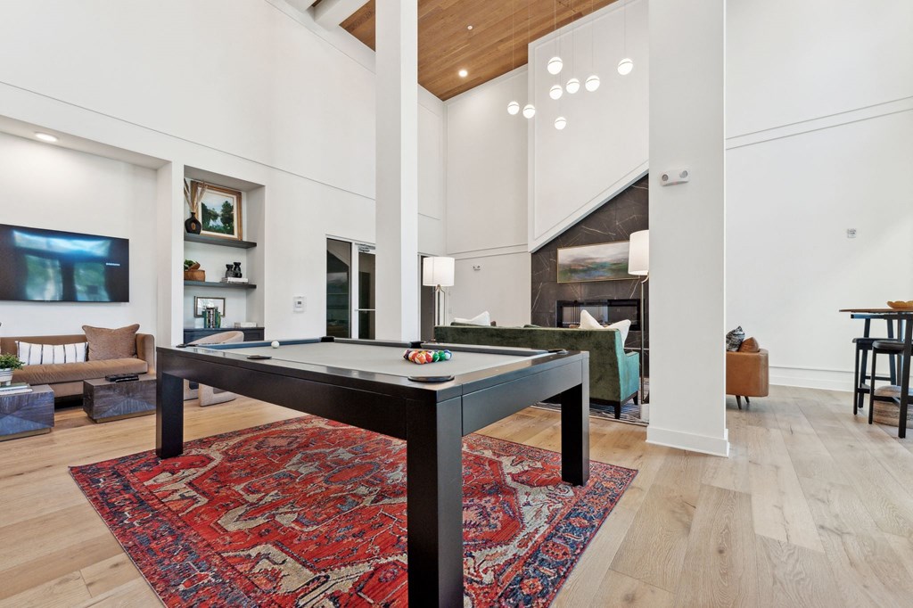 a living room with a pool table in the middle