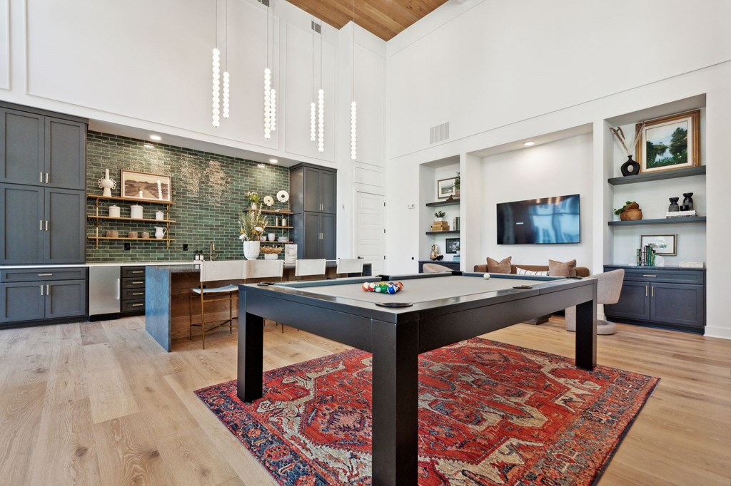 a living room with a pool table in the middle
