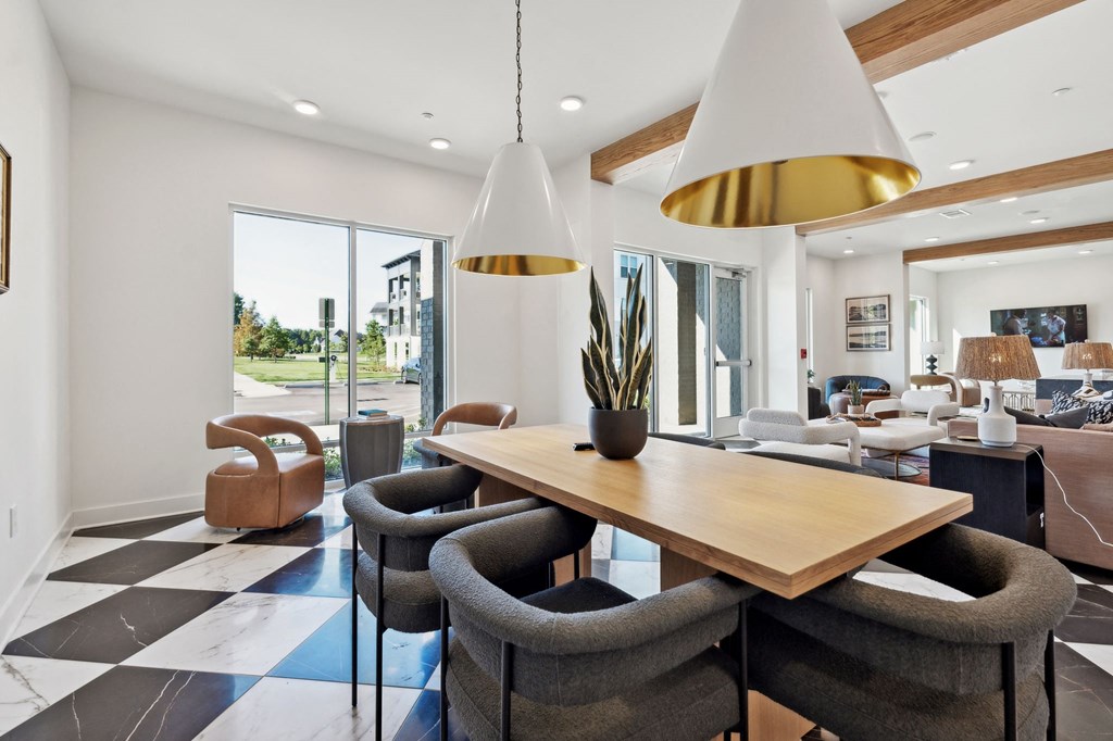 a dining room with a wooden table and chairs