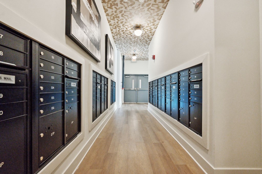a long hallway with a bunch of lockers in a room with wood floors